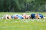 Happy Young Family Lying On Grass Stock Photo