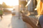 Closeup Women Using Smartphone At Sunset Stock Photo