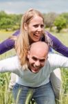 Happy Cute Woman Being Piggy Backed By Her Boyfriend Stock Photo