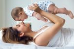 Mother And Baby Playing And Smiling At Home Stock Photo