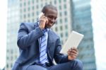 African Executive With Tablet Pc And Cellphone Stock Photo