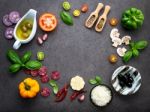 The Ingredients For Homemade Pizza On Dark Stone Background Stock Photo