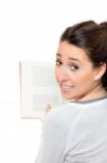 Beautiful Woman Smiling And Reading A Book Stock Photo