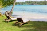 Beach Chairs On The White Sand Beach With  Blue Sky And Sun Stock Photo