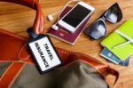 Travel Bag With Insurance Tag And Tourist Accessories Stock Photo