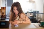 Brunette In Kitchen With Mobile Phone Stock Photo