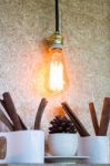 Vintage Hanging Light Bulb Decorated On Brown Wall Stock Photo