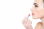 Attractive Teen Girl Applying Red Lipstick Stock Photo