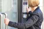 Woman Pushing A Intercom Button Stock Photo