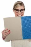 Excited Teen Girl Holding Note Book Close To Her Stock Photo