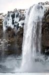 View Of Seljalandfoss Waterfall In Winter Stock Photo