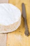 Camembert Cheese And Vintage Knife On Wooden Table Stock Photo