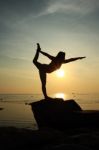 Silhouette Yoga Girl By The Beach At Sunrise Stock Photo