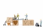 Miniature Worker Team Building Word Love On White Background Stock Photo