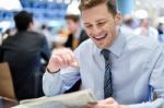 Happy Executive Reading Newspaper At Cafe Stock Photo