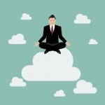 Businessman Meditating On A Cloud Stock Photo