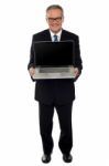 Aged Businessman Showing Newly Launched Laptop Stock Photo