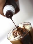 Pouring Syrup Onto Milkshake Stock Photo