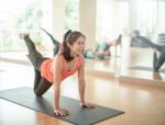 Asian Woman Doing Yoga Indoors Stock Photo