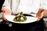 Chef Presenting Healthy Broccoli Salad Stock Photo