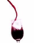 Red Wine Flowing Into The Glass Stock Photo