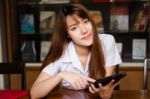 Portrait Of Thai Adult Student University Uniform Beautiful Girl Using Her Tablet Stock Photo