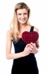 Smiling Young Girl Holding Valentine Gift Stock Photo