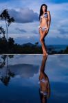 Pretty Brunette Model In Bikini Posing At The Pool Stock Photo