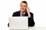 Businessman Working And Talking On Cell Phone Stock Photo