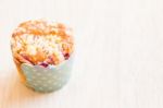 Blueberry Muffins In Paper Cupcake On Wooden Background Stock Photo