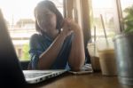 Young Asian Woman Working In Coffee Shop Stock Photo