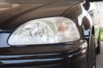 Closeup Headlight Of Black Coupe Stock Photo