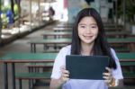 Portrait Of Thai Student Teen Beautiful Girl Using Her Tablet Stock Photo