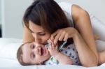 Mother And Baby Playing And Smiling At Home Stock Photo