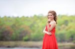 Beautiful Woman Wear Red Evening Dress Over Mountains And Rivers Stock Photo