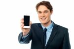 Salesman Displaying Newly Launched Mobile Stock Photo