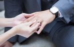 Wedding Ring Put On The Groom's Finger Stock Photo