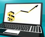 Dollar Sign And Up Arrow On Computer For Earnings Or Profit Stock Photo