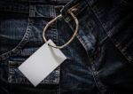 White Card On Wrinkled Jeans Stock Photo