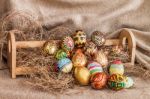 Colorful Painted Easter Egg On Hay In Wooden Shelf Stock Photo