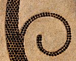 The Abstract Ceramic Spiral On Pebble Background Stock Photo