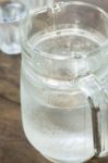 Glass Jar Of Cold Water On Wooden Table Stock Photo