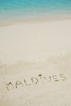 Maldives Written In A Sandy Tropical Beach Stock Photo