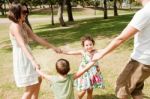 Happy Family Of Four In Park Stock Photo