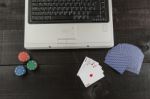 Poker Chips And Cards And A Laptop On Wooden Background Stock Photo