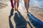 Footprints In The Wet Sand Of The Beach Stock Photo