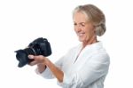 Experienced Female Photographer With Camera Stock Photo