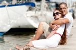 Couple Seated On Footbridge Stock Photo