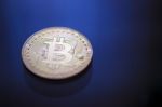 Bitcoin Coin On Blue Light Background Stock Photo