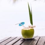 Coconut Water Drink Served In Coconut With Drinking Straw On The Stock Photo